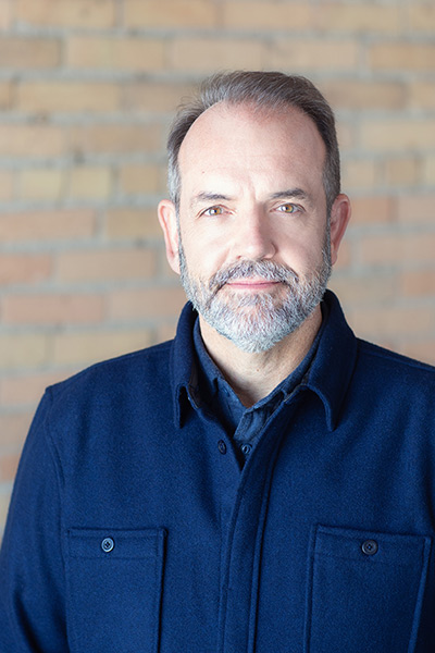 Executive headshot on brick wall